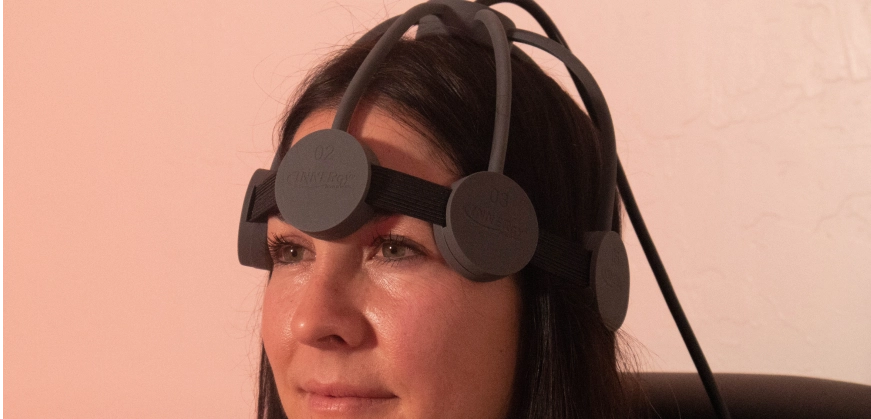 Woman wearing an rTMS machine