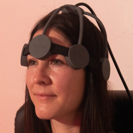 Woman wearing an rTMS machine
